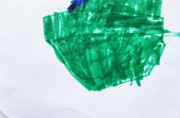 A child's drawing of a green boat. Unless I have it upside down, in which case it's a hat.